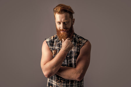 handsome brutal bearded guy in studio. brutal bearded guy on background.の写真素材