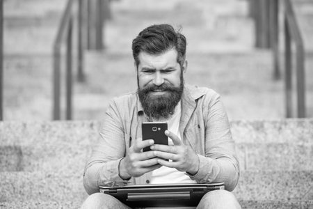 Worrying guy lost bet. Nervous guy checking up betting results in mobile phone. Betting online