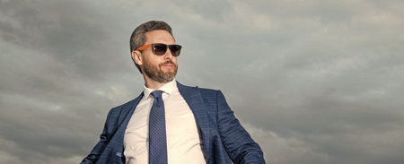 businessman in suit on sky background with copy space. businessman in suit outdoor. businessman in business suit. photo of businessman in suit.の写真素材