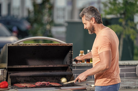 man with hot grill at a barbecue Talented barbecue