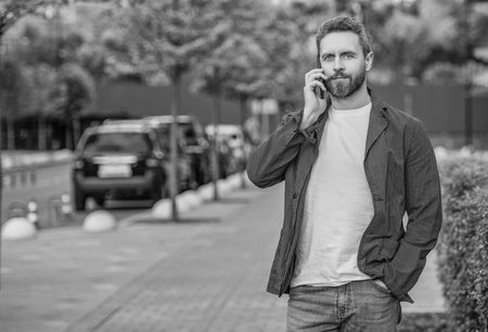 man has mobile call outdoor, copy space. man having mobile call in the street.の写真素材