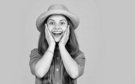 surprised girl in straw hat on yellow backgroundの写真素材