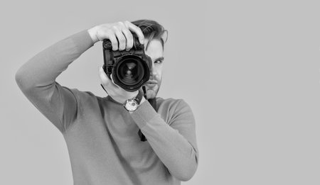 man photographer with photo camera, copy space. photo of man photographer with camera.の写真素材