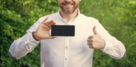 photo of businessman with online app with copy space, thumb up.