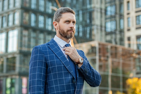 handsome business professional on urban background. business professional wearing jacketの写真素材