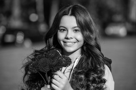 positive teen girl with autumn bouquet outside. photo of teen girl with autumn bouquet.
