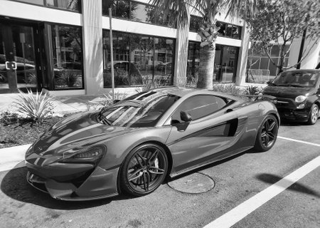 Los Angeles, California USA - March 24, 2021: orange McLaren Automotive Limited 570s left side view.のeditorial素材