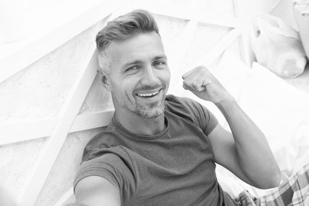 photo of successful selfie man with phone at home. selfie man with phone in bedroom. selfie man with...