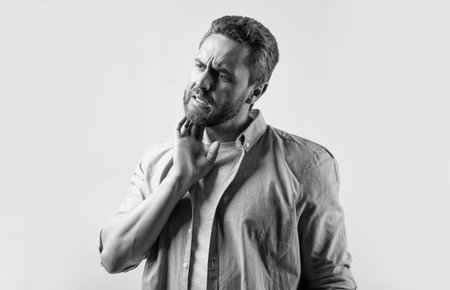 man suffer from itching pain in studio. photo of man with itching pain. man with itching pain. man with itching pain isolated on grey background.の写真素材