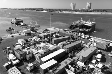Nassau, Bahamas - March 09, 2016: cargo ship and dump containers of scrap metal at harbor