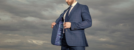 cropped view of man in suit outdoor. man in business suit. photo of man in suit. man in suit on sky background.の写真素材