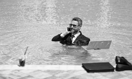 cheerful business manager work in summer. business manager work in summer at swimming pool.の写真素材