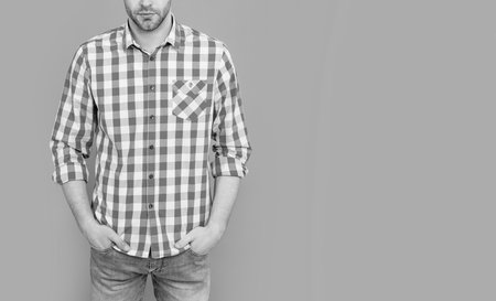 cropped view of guy having stubble. guy in checkered shirt isolated on grey background. guy in casual style. studio shot of guy.の写真素材
