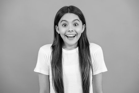 amazed teen girl isolated on grey. amazed teen girl in studio. amazed teen girl on background. photo of amazed teen girl.の写真素材