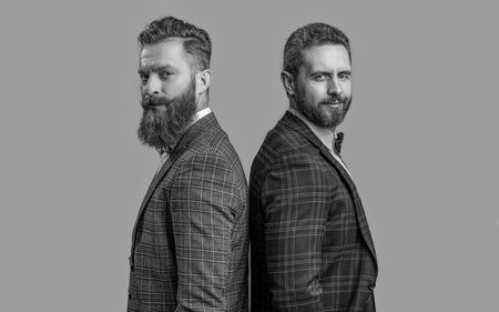 handsome men in tux on background. photo of men in tux suits. men in tux isolated on grey. men in tux at studio.の写真素材