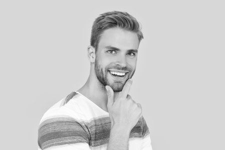 portrait of stylish happy millennial man isolated on yellow background.
