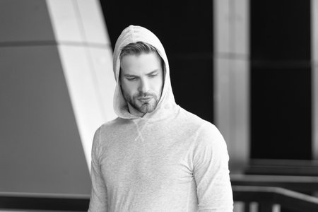 caucasian fitness man in hoodie. fitness man in hoodie outdoor. fitness man in hoodie in the street. photo of fitness man in hoodie.の写真素材