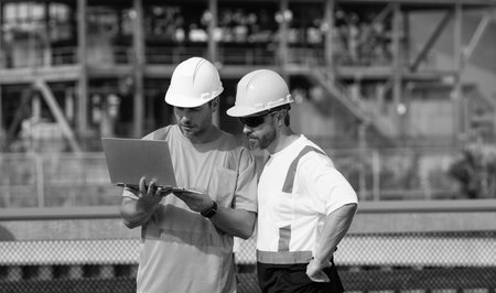 concentrated supervisor men have construction project on laptop. photo of supervisor men with...