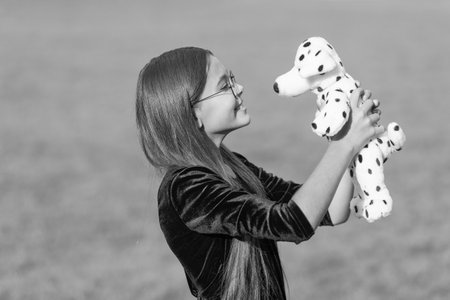 childhood of cheerful playing teen girl. childhood of playing girl with toy. childhood photo of playing girl outdoor. childhood of playing girl.の写真素材