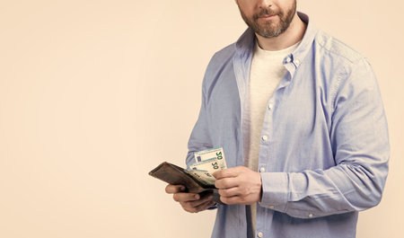 photo of man pay salary, copy space. man pay salary isolated on studio background. man pay salary in studio. man pay salary banknotes.の写真素材