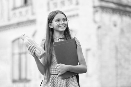 photo of cheerful school girl at september season outdoor.の写真素材