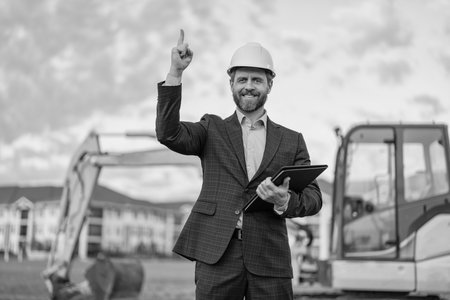 inspired with idea supervisor check business project at site. supervisor checking business project outdoor. photo of supervisor with business project in hardhat. supervisor with business project.の写真素材