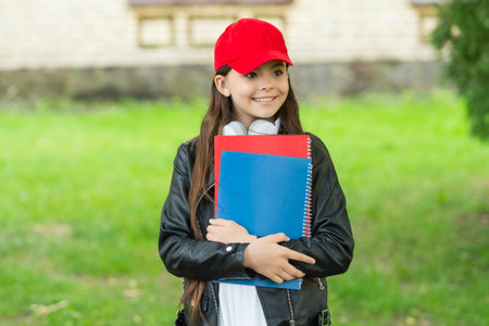 September 1. Knowledge and education. Knowledge day in September. Girl in cap hold school homework....