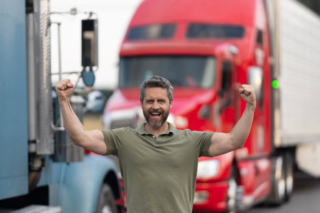 Man driver near lorry truck. Truck driver. Trucking owner. Transportation vehicles. Hispanic man posing in front of truck. Semi trucks vehicle. Man successful owner truck driver.の写真素材