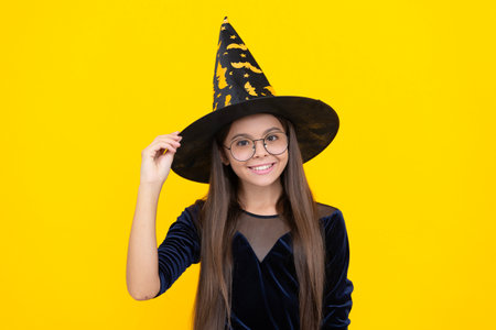 October 31. Teen girl in witch costume. Happy Halloween. Girl witch in Halloween costume isolated on...