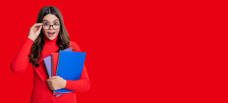 Girl student isolated on red. September 1. Copy space advertisement. Knowledge and education. School education. Students life. Teen girl back to school. Knowledge day. Education in college.の写真素材