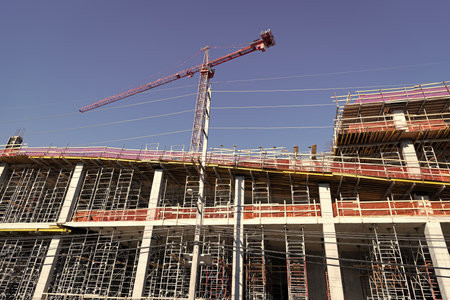 Construction at building site with crane. Construction crane at building area. Construction site...