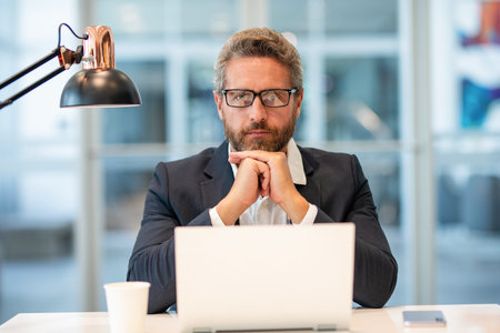 Freelance working online. Serious man using laptop in office. Business freelancing. Man office manager. Businessman has online business. Businessman success. Freelancer man work onlineの写真素材