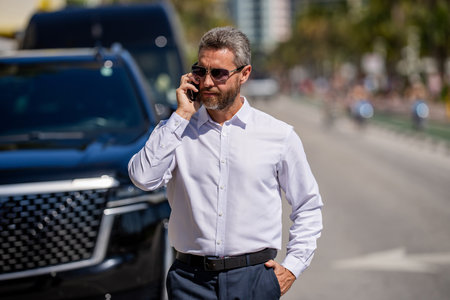 Businessman using phone. Business call. Man phone conversation. Mature Hispanic business man with...