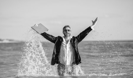 Businessman excited in sea. Business man in wet suit in sea water. feel happiness. successful businessman finally relaxing. businessman has success. successful business dealの写真素材