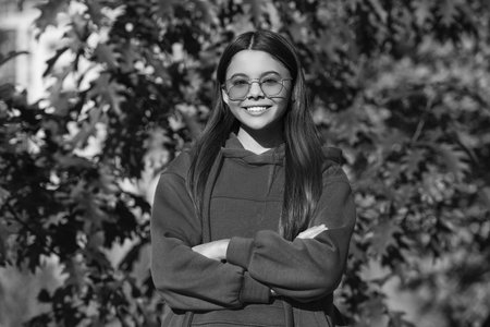Autumn teen girl wearing in sunglasses and looks stylish. Fall season. Girl dreams in autumn fall....