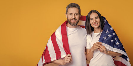 patriotism of couple with the American flag, banner. Celebrating the American spirit couple draped...