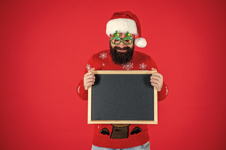 Xmas advertisement, copy space. Christmas shopping sale. Happy New Year. Xmas holiday advertisement. Santa Claus man offer New Year sale. Santa man offer holiday shoppingの写真素材