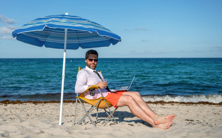 Businessman office worker. Business man using laptop in beach. Travel and business. Man freelance...