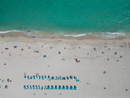 Beach vacation at sea in summer. Sea relax under beach umbrella. Travel to sea. Aerial top view of sand beach with crystal clear turquoise water. Summer vacation in paradiseの写真素材