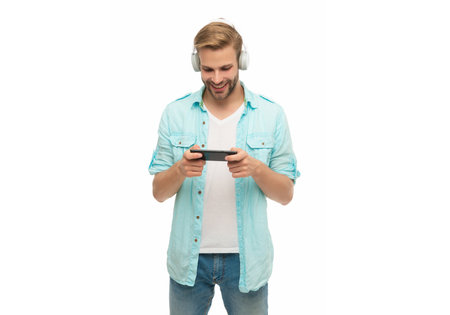 Man gamer in headphones play video game online with smartphone. Man using smartphone for gaming...
