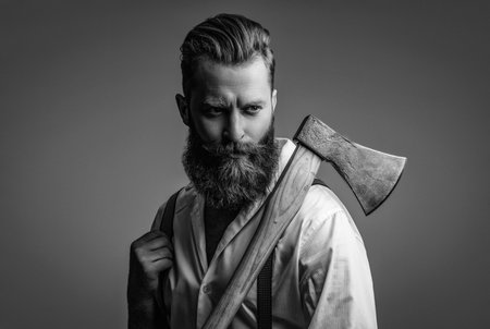 Handsome bearded man. Beard styling. Caucasian hipster with moustache. Bearded man isolated on grey....