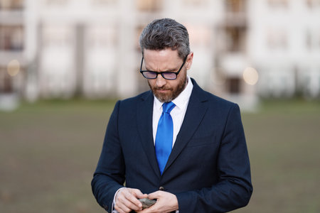 House owner hold money outdoor. Realtor offering new home. Broker make offer. Businessman broker count money. Property concept. Successful realtor in suit with money dollarの写真素材