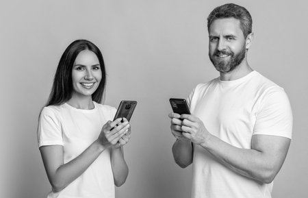 Connected online. Chatting on phone. Couple chat online. Family couple blogging. Modern phone...