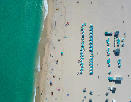Sea relax under beach umbrella. Travel to sea. Top view of sand beach with turquoise water. Luxury...