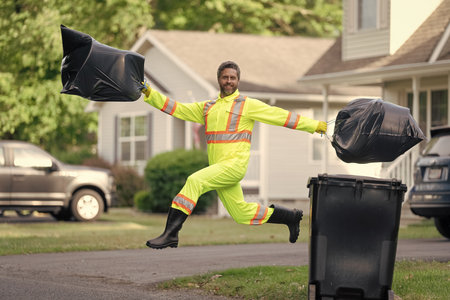Keeping garbage plastic into bag for trash. Pollution and recycling. Man putting garbage bag in a...