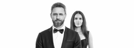 Woman in dress and man in suit with bowtie. Elegant couple isolated on white. Romantic couple spending time together. Two of man and woman on valentines day. Lovely couple dating. Fashion pairの写真素材