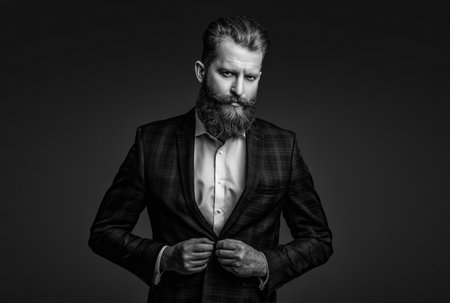 Man businessman in bespoke formalwear. Business man in elegant tailored suit. Formal tailored suit. Gentleman menswear. Bespoke suit. Bearded man in tailored formal menswear. Eveningwear ensembleの写真素材