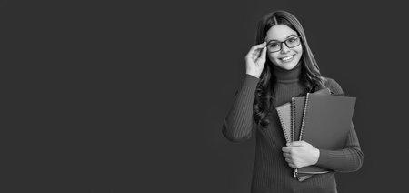 School education. Students life. Teen girl back to school. Knowledge day. Education in college. Girl student isolated on red. September 1. Copy space banner. Knowledge and educationの写真素材