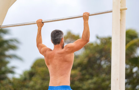 Muscular biceps and triceps. Strong athlete. Man pullup. Muscular man sportsman with strong back...