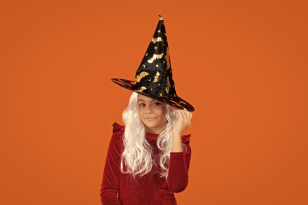 Girl in Halloween witch costume. Happy Halloween. Girl witch in Halloween costume isolated on...